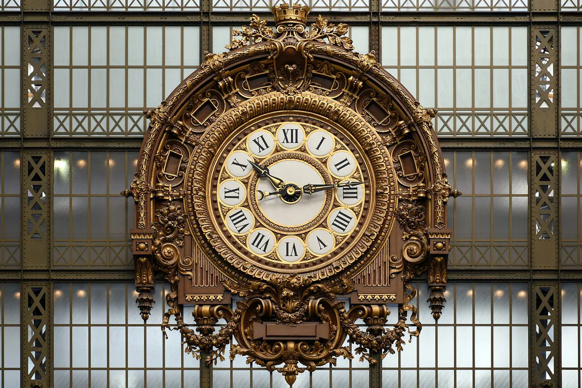 The large clock behind the glass wall of the Musée d'Orsay, daytime
