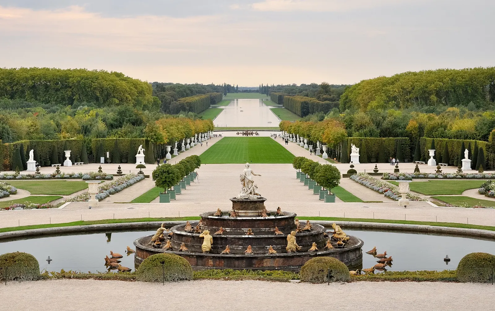 Latona Fountain with gilded statues in the foreground and the Royal Walk running to the Grand Canal, Gardens of Versailles, early autumn